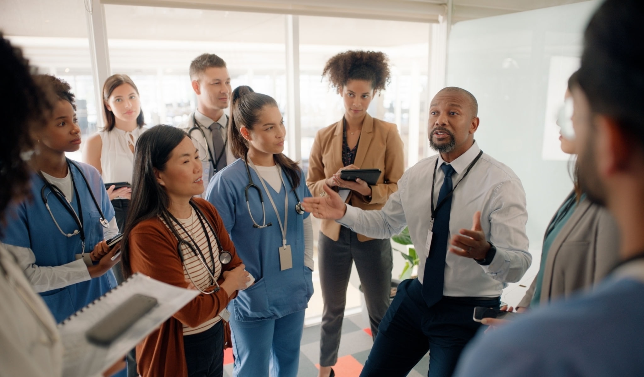 Healthcare team leader presenting to staff in a boardroom